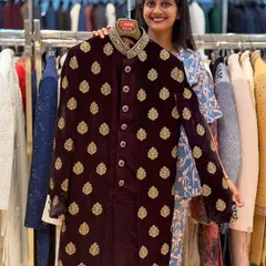 For a rich, royal look, this maroon velvet sherwani with gold embroidered motifs is an excellent choice. It’s a classic combination that looks grand in person and in photos.
