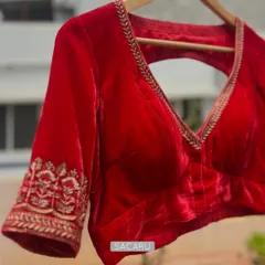 A bright red velvet blouse is perfect for brightening up any saree. We designed this piece with a deep V-neck and delicate zardosi embroidery on the sleeve cuffs.