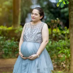 A solo shot of the mother wearing a stunning sequined and ruffled grey gown. This highlights one of the elegant options available for rent from my client closet.