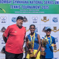 Two champions holding their trophies. Trisha Bhosale and her doubles partner after their victory at the Bombay Gymkhana National Series. We emphasize strong doubles strategy in our training.
