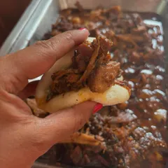 A soft, fluffy bao bun generously stuffed with my signature pulled pork. It's a wonderful snack or appetiser, especially when paired with a refreshing drink.