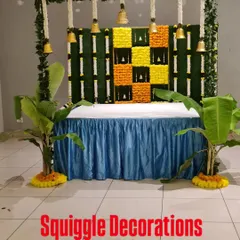 A traditional decoration for Ganesh Chaturthi. The backdrop is made of marigold flowers and banana leaves, with hanging temple bells creating a sacred ambiance.