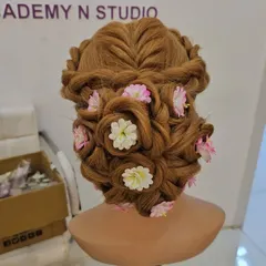 Hairstyling is a key skill for any professional artist. Here is an intricate floral updo created on a mannequin during a practice session. My course covers everything from basic braids to complex international bridal updos.