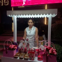 A proud moment behind our gifting station at an evening event. The scalloped roof and clean white frame are designed to look charming in any setting, day or night. This is the welcoming space where your guests will come to choose their personal thank you gift.