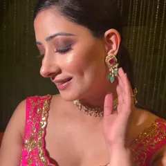 A pop of pink for a bridesmaid or guest look. This style features a soft smokey eye with pink undertones, paired with glowing skin for a fresh and festive feel.