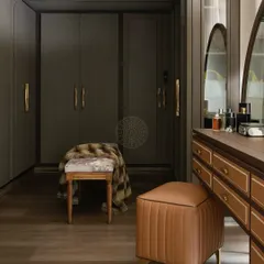 This classic walk-in closet features dark wood wardrobes with diamond-patterned details and elegant brass handles. A leather-upholstered vanity stool adds a touch of warmth and luxury.