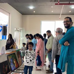 I love exhibiting my work and connecting with people. Here I am at a cultural event in my apartment clubhouse, where I had the chance to display my life's work and chat with neighbors and art lovers.