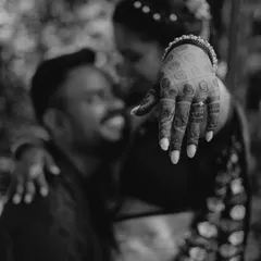 An artistic, shallow-depth-of-field shot focusing on the bride's hand and engagement ring. This black and white photo is both romantic and creative.