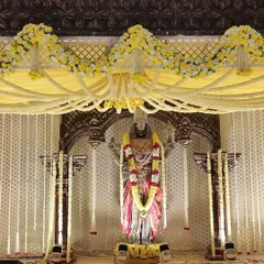 A closer look at the deity and the floral work on the mandap. You can see the layers of tuberose garlands and the yellow floral arrangements that frame the main arch.
