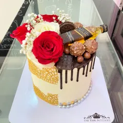A half-and-half cake design. One side is elegant with lace and roses, while the other is a chocolate lover's dream with a Johnnie Walker Black Label theme.