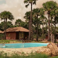 These resort villas are nestled within a coastal oasis of palm trees. The design uses traditional thatched roofs and locally sourced materials to create a tropical retreat that feels both authentic and luxurious.