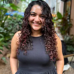 A beautiful smile from a client loving her new no bleach hair colour. The warm tones complement her skin and bring out the definition in her curls.