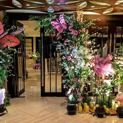 An enchanting entrance for a whimsical Sangeet. I used oversized, colorful butterflies nestled within lush floral arrangements and surrounded by candles to create a magical and theatrical welcome for guests.