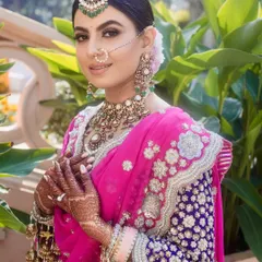A closer look at the harmonious balance between hair, makeup, and jewellery for this Sikh bride. The floral bun is visible at the back, adding a touch of softness to the overall regal and traditional wedding look.
