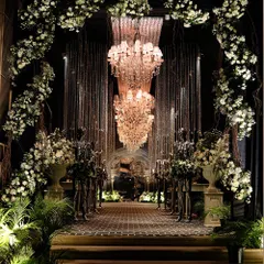 An opulent entrance for a glamorous black-tie event. I used grand chandeliers, lush white floral arches, and dramatic lighting to create an unforgettable first impression.