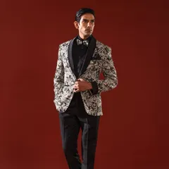 For the man who appreciates bold elegance, this tuxedo jacket features a striking black and white paisley print. Paired with a black formal shirt and trousers, it creates a confident and stylish look for any celebratory event.
