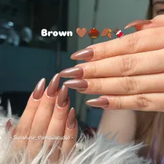 A simple yet stunning set of stiletto nails in a shimmery, metallic brown polish.