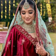 A moment of quiet beauty before she walks down the aisle. The focus here is on the flawless, soft-matte skin and the beautifully blended smokey eye, creating a look that is both classic and breathtaking.