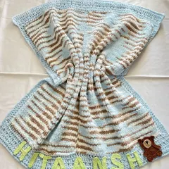 This is our premium "Cuddle Blanket," and it's as soft as it looks. Unlike our other blankets, this one is knitted to create an extra plush and heavy feel. We personalized this one with the baby's name, "Hitaansh," and a small teddy bear appliqué, making it a truly unique newborn gift.