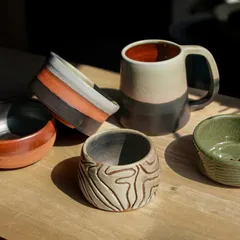 A collection of student pieces from our Feb-Apr cohort, featuring a variety of forms and surface decoration techniques like carving and layering glazes.