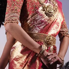 Details matter, right down to the sleeve cuffs. This close-up shows the edge of a heavily embroidered sleeve, finished with a delicate line of small pearls that add a final touch of elegance.