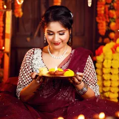 A close-up of the Diwali makeup, with shimmering eyeshadow and perfectly defined features, illuminated by the soft light of a diya.