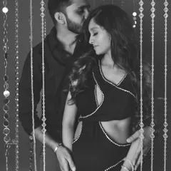 A tender moment between partners, captured in timeless black and white. This style emphasizes the emotion and connection, creating a truly romantic maternity portrait.