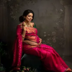 A seated portrait in a stunning pink silk saree. The pose is full of grace, and the rich fabric drapes so beautifully.