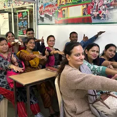 A classroom of smiling parents during our orientation program. We aim to improve parent-child interactions by helping parents anticipate developmental changes and provide early learning experiences.