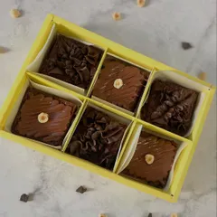 A box of six assorted eggless brownies, showcasing our hazelnut and chocolate fudge varieties. The perfect duo for any chocolate and nut lover.