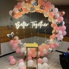 We can add thematic elements like these beautiful silver butterflies to any setup. Here, they add a whimsical and delicate touch to a "Better Together" ring backdrop for an anniversary or engagement party.