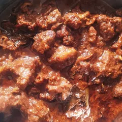This is Kawsha Mangsho, a timeless Bengali classic. It’s a dry, slow-cooked mutton dish where the magic lies in the caramelization of spices and meat. The rich, dark gravy is perfect for scooping up with luchi or parathas.