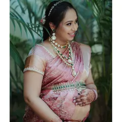 Celebrating the strength and beauty of motherhood. This portrait was taken during a garden maternity session, capturing the mother-to-be's serene glow. Dressed in a stunning pink silk saree and traditional jewelry, she embodies grace and anticipation.