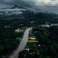 An aerial view of the roads winding through the lush green landscape of Krabi. The journey is just as beautiful as the destination.