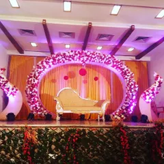This full view of the circular stage design shows how it commands the space. The flanking floral arrangements and warm lighting complete this stunning setup for a memorable wedding or engagement.