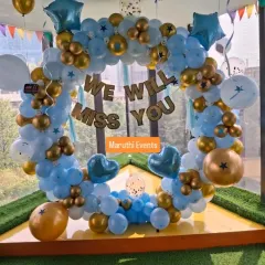 A heartfelt 'We Will Miss You' farewell party decoration. The blue, white, and gold balloon ring provides a beautiful backdrop for photos and goodbyes.