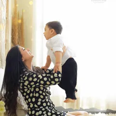 The pure joy of a mother playing with her child. This candid moment, captured in our studio, perfectly shows the loving and playful bond they share.