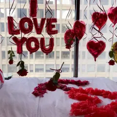 A close-up look at the details, including the 'I LOVE YOU' foil balloons and individual roses attached to hanging ribbons. Every element is placed with care to create the perfect romantic mood.