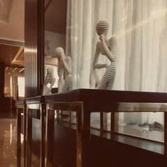 These thought-provoking sculptures, with their unique layered texture, add a contemplative and artistic touch to this modern living space. They are perfect conversation starters.