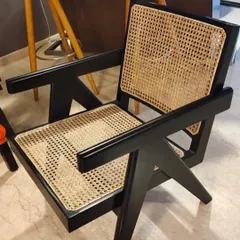 This is my reproduction of the iconic Pierre Jeanneret V-leg armchair, finished in a striking black polish. I build these chairs using solid teak and hand-woven cane, staying true to the original 1950s design principles for a piece that is both a collector's item and a comfortable seat.