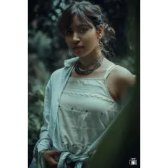 An outdoor portrait with a cool, moody tone. The layered outfit and natural, slightly messy hair give this shot an authentic and bohemian feel, perfect for a candid lifestyle portfolio.