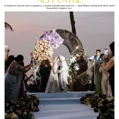 A magazine-style shot of the couple's first kiss as husband and wife. This captures the epic scale of their Dubai wedding, with the sunset and floral arch creating a breathtaking scene.