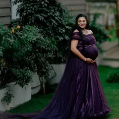 For all the moms-to-be, I design gowns that celebrate you. This deep purple off-shoulder maternity gown features a delicate tulle fabric and a long trail, creating a look of pure elegance for your maternity photoshoot.