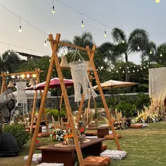 A key feature of this boho setup was the A-frame swing structures with low tables and floor cushions, creating fun and interactive seating areas for guests.