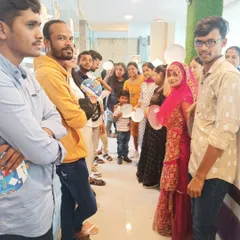 Students lining up for a fun game during a potluck event. We integrate interactive activities into our community gatherings to make practicing English feel natural and enjoyable.