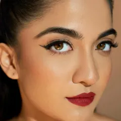 For the bride who loves a bold statement, this look is all about precision. A sharp, graphic winged liner paired with a classic matte red lip creates an unforgettable and glamorous style, perfect for a cocktail or reception event.