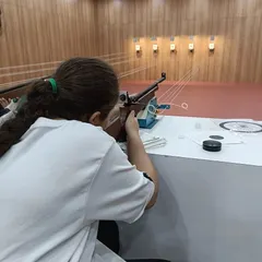 A participant gets her first taste of air rifle shooting during one of our open sessions. Our coaches are always on hand to assist with posture, aiming, and safety.
