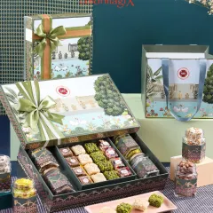 This exquisite hamper, featuring intricate illustrations and a beautiful satin bow, blends wellness and indulgence. Inside, a curated selection of gourmet sweets and premium dry fruits awaits, making it a perfect gift for any festive occasion.