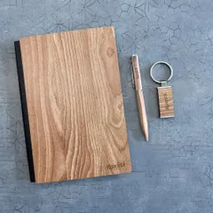 This simple yet elegant set features a light-wood diary and keychain personalized for "Ramith", along with a matching pen. It's a great example of a minimalist and personal wooden gift.