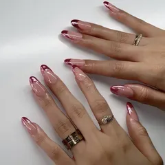 A romantic and edgy chrome design. These long stiletto nails feature a beautiful metallic pink chrome applied as a deep French tip, offering a futuristic yet feminine look for your bachelorette or cocktail party.